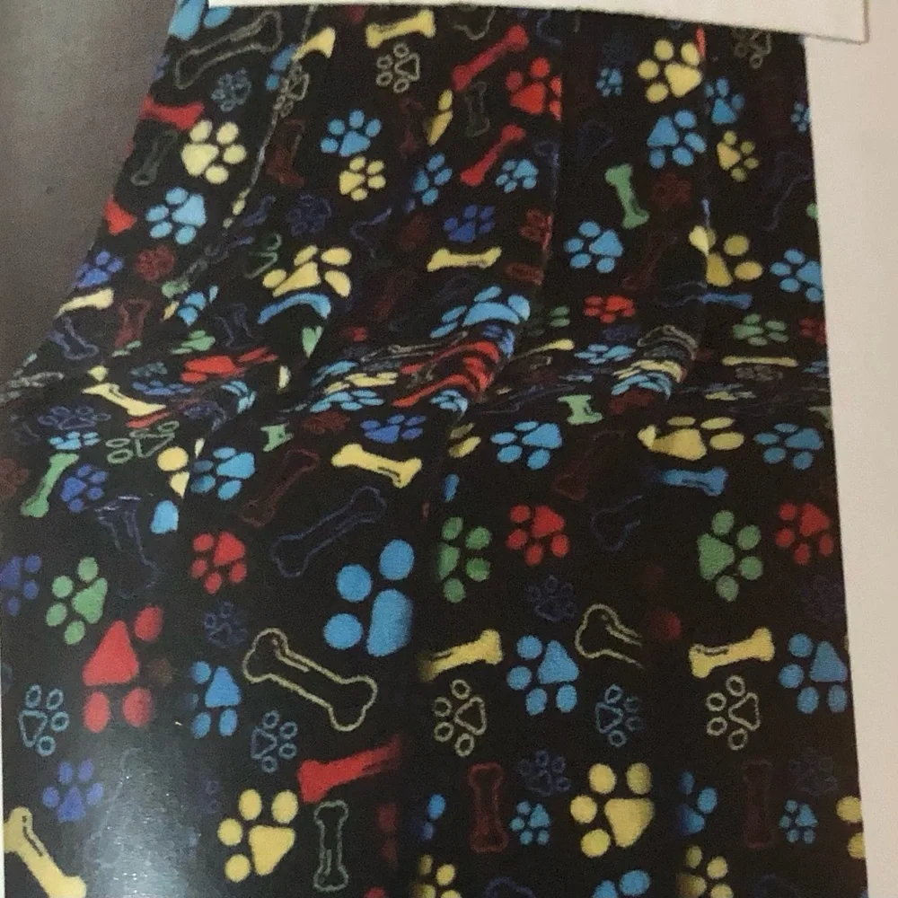 Black Plush Blanket Roll with Multicolor dog bones and Paw Print Pattern. 50X60